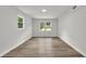 Bedroom with wood floors, white walls, and natural light from windows at 336 Fond Du Lac Dr, Stone Mountain, GA 30088