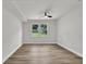 Bedroom with wood floors, white walls, ceiling fan, and natural light at 336 Fond Du Lac Dr, Stone Mountain, GA 30088