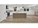 Modern kitchen with white cabinetry, quartz countertops and a decorative kitchen island at 336 Fond Du Lac Dr, Stone Mountain, GA 30088