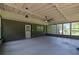 Enclosed patio with grey floors, ceiling fans, and multiple windows at 336 Fond Du Lac Dr, Stone Mountain, GA 30088