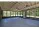 Enclosed patio with grey floors, ceiling fans, and a view of the yard at 336 Fond Du Lac Dr, Stone Mountain, GA 30088