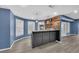 Basement bar with stone counter top, bar stools and accent lighting at 3451 Falls Branch Ct, Buford, GA 30519
