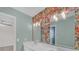 Modern bathroom features double vanity, floral wallpaper, and stylish light fixtures at 3451 Falls Branch Ct, Buford, GA 30519