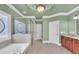 Elegant bathroom features a soaking tub, glass shower, and stained glass window at 3451 Falls Branch Ct, Buford, GA 30519
