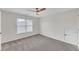 Bedroom with neutral walls, carpet, a window, and a ceiling fan at 3451 Falls Branch Ct, Buford, GA 30519