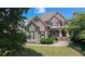 Charming brick home with manicured lawn and inviting front porch, showcasing curb appeal at 3451 Falls Branch Ct, Buford, GA 30519