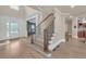 Inviting foyer with staircase and views into adjacent rooms at 3451 Falls Branch Ct, Buford, GA 30519