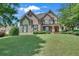 Attractive brick home featuring shuttered windows and a well-manicured lawn at 3451 Falls Branch Ct, Buford, GA 30519