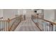 Hallway with carpet, railing, and cabinets at 3451 Falls Branch Ct, Buford, GA 30519