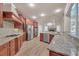Gourmet kitchen features cherry wood cabinetry, granite countertops and stainless appliances at 3451 Falls Branch Ct, Buford, GA 30519