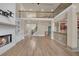 Open-concept living room with a fireplace, built-in shelves, and hardwood floors at 3451 Falls Branch Ct, Buford, GA 30519