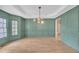 Elegant living room with paneled walls, hardwood floors, and modern lighting at 3451 Falls Branch Ct, Buford, GA 30519
