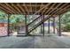 Covered patio area offering an outdoor living space and stairs leading up to the backyard at 3451 Falls Branch Ct, Buford, GA 30519