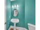 Stylish powder room featuring a pedestal sink and modern lighting fixtures at 3451 Falls Branch Ct, Buford, GA 30519