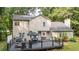 Backyard featuring a large deck with a grill and seating area, all with lush landscaping at 5679 Bay Harbor Nw Trl, Acworth, GA 30101