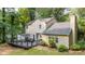 Backyard featuring a large deck with grill and seating and mature trees in the landscaping at 5679 Bay Harbor Nw Trl, Acworth, GA 30101