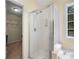 Well-lit bathroom highlighting a glass-enclosed shower and walk-in closet at 5679 Bay Harbor Nw Trl, Acworth, GA 30101
