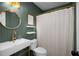Stylish bathroom with a modern vanity, gold accents, and a shower with a patterned curtain at 5679 Bay Harbor Nw Trl, Acworth, GA 30101
