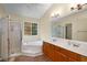 Bright bathroom featuring double sinks, garden tub, and separate shower offering a luxurious retreat at 5679 Bay Harbor Nw Trl, Acworth, GA 30101