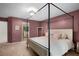 Spacious bedroom featuring a four-poster bed and soft carpet, creating a cozy retreat at 5679 Bay Harbor Nw Trl, Acworth, GA 30101