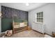 Charming Bedroom with a decorative wall, wooden crib, and changing table, creating a cozy space at 5679 Bay Harbor Nw Trl, Acworth, GA 30101