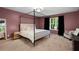Well-lit bedroom featuring a four-poster bed, soft carpet, and modern decor, creating a tranquil retreat at 5679 Bay Harbor Nw Trl, Acworth, GA 30101