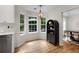 Charming breakfast nook with bright windows, wood floors, and modern black shelving; adjacent to the kitchen at 5679 Bay Harbor Nw Trl, Acworth, GA 30101