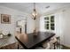 Bright dining room featuring a modern chandelier, stylish decor, and a glimpse into the well-appointed kitchen at 5679 Bay Harbor Nw Trl, Acworth, GA 30101
