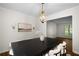 Neutral-toned dining area featuring a substantial table, chandelier and decor at 5679 Bay Harbor Nw Trl, Acworth, GA 30101