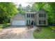 Traditional two-story home with a two-car garage, manicured lawn, and mature trees at 5679 Bay Harbor Nw Trl, Acworth, GA 30101