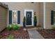 Charming front entrance with a black door, decorative wreath, and manicured landscaping at 5679 Bay Harbor Nw Trl, Acworth, GA 30101