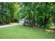 Spacious front yard with mature trees shading the charming two-story home at 5679 Bay Harbor Nw Trl, Acworth, GA 30101