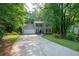 Charming home with a lush front lawn, mature trees, and a two-car garage at 5679 Bay Harbor Nw Trl, Acworth, GA 30101