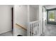 Bright staircase with white railings; transitioning to cozy bedrooms with plush gray carpeting for comfort at 5679 Bay Harbor Nw Trl, Acworth, GA 30101