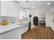 Bright kitchen featuring white cabinets, quartz countertops, gold hardware, and stainless steel appliances at 5679 Bay Harbor Nw Trl, Acworth, GA 30101