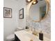 Stylish powder room with elegant floral wallpaper, gold mirror, and modern fixtures at 5679 Bay Harbor Nw Trl, Acworth, GA 30101