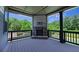 Cozy screened-in porch featuring a stone fireplace and wooded views, perfect for enjoying the outdoors at 1231 Fawndale Nw Dr, Kennesaw, GA 30152