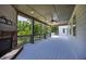An inviting covered porch with a stone fireplace, ceiling fan and open views to the surrounding nature at 1231 Fawndale Nw Dr, Kennesaw, GA 30152