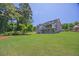 Expansive backyard featuring a lush lawn and multi-level deck, perfect for outdoor entertaining at 1231 Fawndale Nw Dr, Kennesaw, GA 30152
