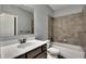 Bathroom featuring a vanity with a modern faucet and a tub with tiled walls at 1231 Fawndale Nw Dr, Kennesaw, GA 30152