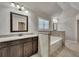 An inviting bathroom features granite counters and a tiled tub surround at 1231 Fawndale Nw Dr, Kennesaw, GA 30152