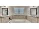 This bathroom features a soaking tub with granite counter and tiled surround at 1231 Fawndale Nw Dr, Kennesaw, GA 30152