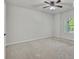 Spacious empty bedroom with neutral carpet, a large window, and recessed ceiling light at 1231 Fawndale Nw Dr, Kennesaw, GA 30152