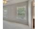 Bedroom featuring gray carpet, two windows and view into adjacent room at 1231 Fawndale Nw Dr, Kennesaw, GA 30152
