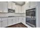 Well-appointed kitchen with white cabinets, stainless steel appliances, granite countertops, and subway tile backsplash at 1231 Fawndale Nw Dr, Kennesaw, GA 30152