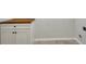 Neat laundry room features a wooden countertop and white cabinets at 1231 Fawndale Nw Dr, Kennesaw, GA 30152
