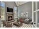 Cozy living room featuring a stone fireplace, comfortable seating, and natural light from large windows at 1231 Fawndale Nw Dr, Kennesaw, GA 30152