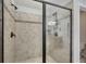 This tiled shower features a glass door and updated fixtures at 1231 Fawndale Nw Dr, Kennesaw, GA 30152