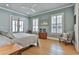Spacious bedroom with hardwood floors, ceiling fan, and French doors at 175 Central Ave, Fayetteville, GA 30214