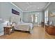 Light filled main bedroom with hardwood floors, ceiling fan, and French doors at 175 Central Ave, Fayetteville, GA 30214